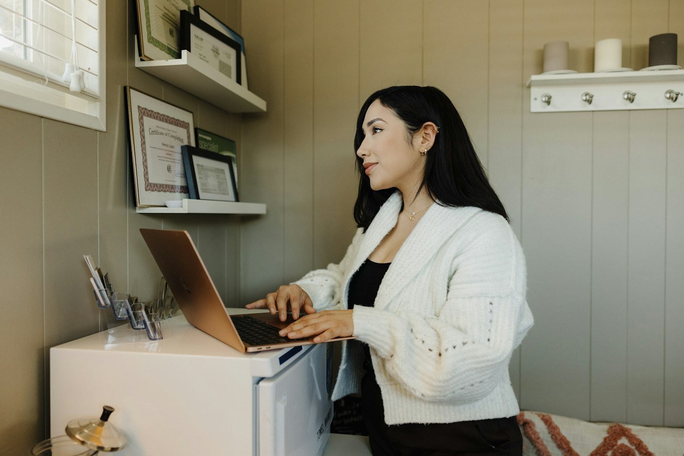 Woman developing a custom software application on a laptop at her home office